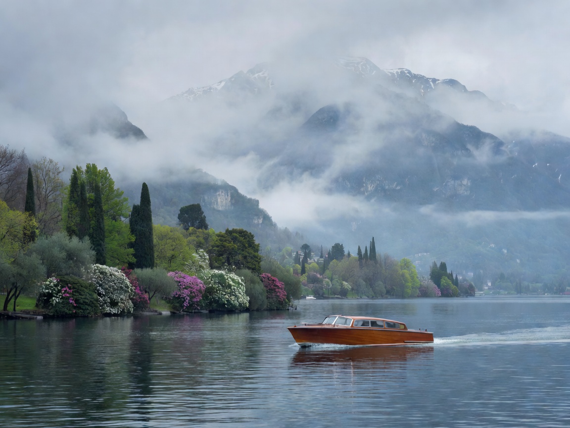 Water taxi cruising past misty mountains on Lake Como in late spring